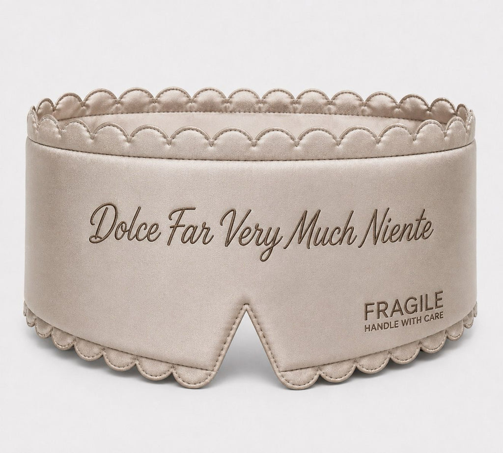 Fragile satin sleep mask in Oyster, padded with scalloped stitched edge and tonal embroidered script