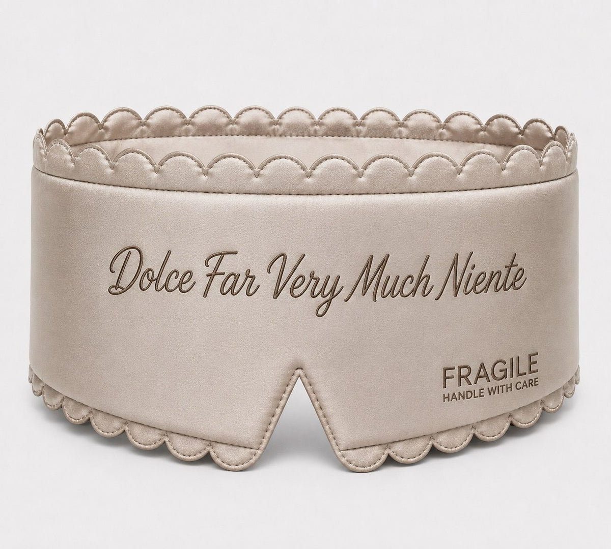 Fragile satin sleep mask in Oyster, padded with scalloped stitched edge and tonal embroidered script