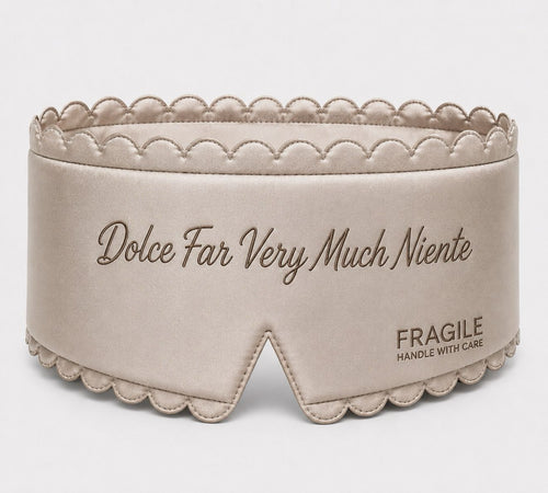 Fragile satin sleep mask in Oyster, padded with scalloped stitched edge and tonal embroidered script